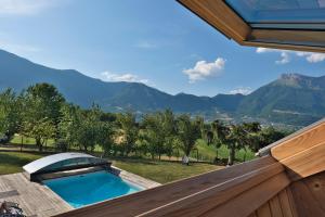 a swimming pool with mountains in the background at AlpiZen centre de Ressourcement - Adults recommended in Coise-Saint-Jean-Pied-Gauthier +62 photos