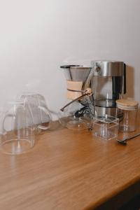 a counter with a coffee maker and glasses on it at Hotel Boutique Casa Yága in Querétaro