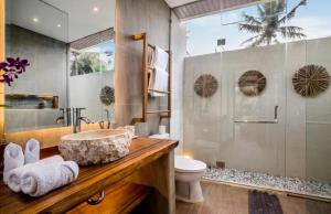 a bathroom with a sink and a toilet at Sun Dancer 2 BR Pool Villa Ubud CYN in Mantaak +14 photos