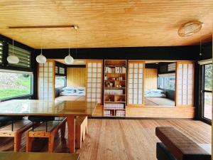 a dining room with a table and some windows at 晴天慢旅 Lumière in Xiaoliuqiu