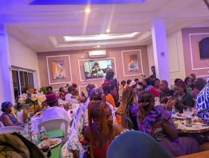 a group of people sitting at tables in a room at The Blue Resort in Yaoundé +48 photos