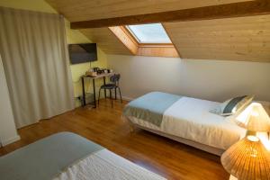 a bedroom with two beds and a desk with a window at AlpiZen centre de Ressourcement - Adults recommended in Coise-Saint-Jean-Pied-Gauthier