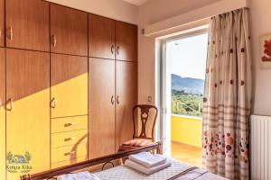 a bedroom with a bed and a window at Ktima KiKa - Private Pool Escape & Tranquility in Kyparissia +43 photos