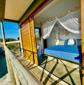 a bedroom with a canopy bed on a balcony at Villa Beleza Prea Beachfront private room in Prea +29 photos