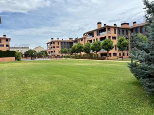 a large grassy field in front of a building at AIzaetxea in Jaca