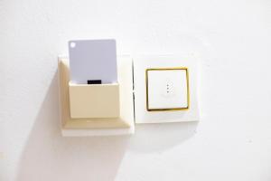 a white lightswitch with a white phone in it at GodIsGood Residency in Yaoundé