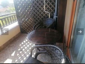 a table and two chairs on a balcony at apartment Marina hill in Chernomorets