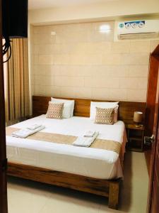 a bedroom with a large bed with two towels on it at Studio 69 Aparthotel in Iquitos +96 photos