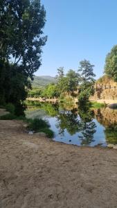 a body of water with trees in the background at La Guinda del Jerte Apartamento Turistico in Cabezuela del Valle