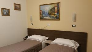 Postel nebo postele na pokoji v ubytování Hotel Tommaseo