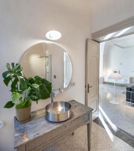 a bathroom with a sink and a mirror at Palazzo Alchimia in Fasano +23 photos