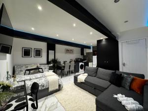 a living room with a couch and a bed at Gorgeous Holiday Home 5 minutes from Central London in London