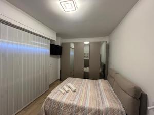 a bedroom with a bed and a television in it at BeB Loft Corigliano Rossano CS in Rossano Stazione