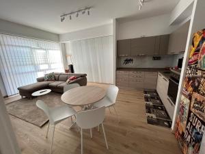 a kitchen and a living room with a table and chairs at BeB Loft Corigliano Rossano CS in Rossano Stazione +2 photos