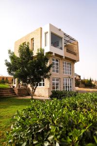 a house with a window on the side of it at Farmhouse Loft Apartment at Mogador Essaouira 