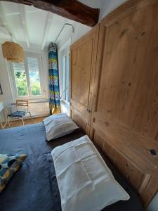 a bedroom with a large bed with a wooden wall at Lin et l'hôte in Préaux
