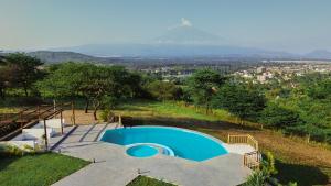 a blue swimming pool on top of a hill at Mateves boutique lodge in Arusha