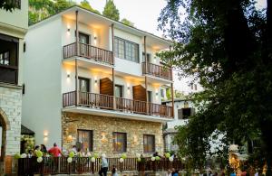 a building with people standing outside of it at Balcon Makrinitsa in Makrinitsa