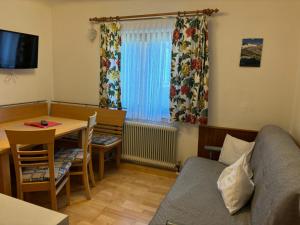 a small living room with a table and a couch at Appartement Unterstein 1 in Niedernsill