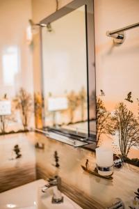 a bathroom sink with a mirror and a cup on it at Royal Crest Villa in Batawala +33 photos