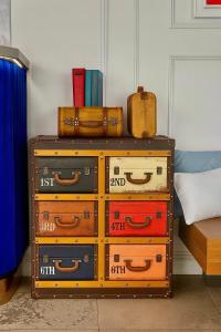 a pile of suitcases sitting on top of a dresser at პანორამა კვარიათი in Kvariat'i