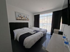 Postel nebo postele na pokoji v ubytování Hotel Oti