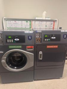 a washing machine and a dryer next to each other at El Albuergo in Llanes +14 photos