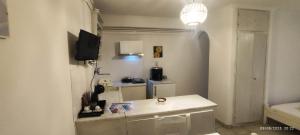a living room with a table and a television at Dandelion Paros Apartments I-II in Kóstos +42 photos
