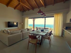 a living room with a table and a couch at Thaleri Villa in Pyrgi