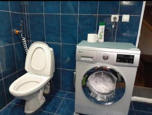 a bathroom with a toilet and a washing machine at holiday home in Borjomi +21 photos