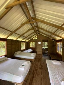 a bedroom with three beds in a room at Hibiscus House Nuquí in Nuquí