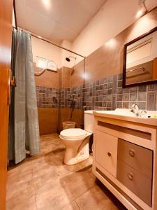 a bathroom with a toilet and a sink at The Reo Lodge, Haridwar in Haridwār