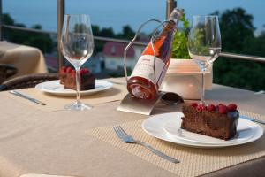 a table with a piece of cake and a bottle of wine at For You in Odesa