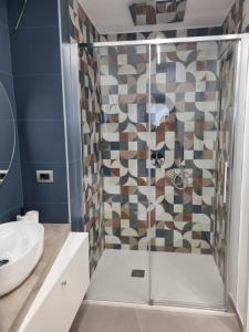 a bathroom with a shower and a sink at Suite Dolce Amore in Venosa