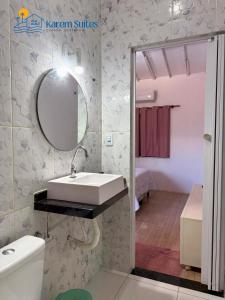 a bathroom with a sink and a mirror at Karem Suítes in Canoa Quebrada +46 photos