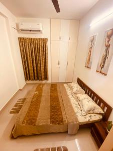 a bedroom with a large bed in a room at MIRA VISTA - Cozy 2 BHK Condo - Chennai in Chennai +1 photo