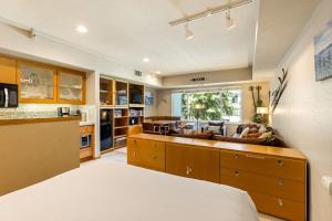 a kitchen and living room with a bed and a couch at Palisades Tahoe Lodge Rentals Studio #207 in Olympic Valley