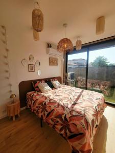 a bedroom with a bed and a large window at Bohème Chic in Albi