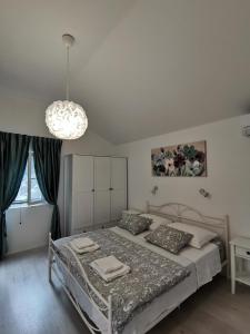 a bedroom with a bed and a chandelier at Accommodation Susović in Lastovo