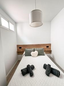 a bedroom with a large white bed with two pillows at Loft Molino de Erillas in Alora