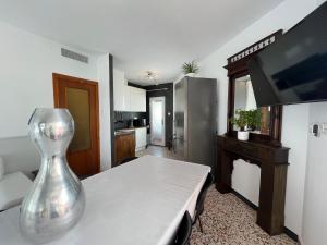 a living room with a table with a vase on it at El Rincón de PaLu in San Pedro del Pinatar