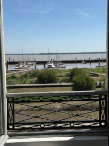 a balcony with a view of a harbor with boats at La Belle Escale in Pauillac