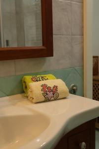 a bathroom sink with a towel on top of it at Casa Flaùti Sorrento in Piano di Sorrento