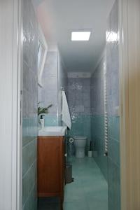 a bathroom with a sink and a toilet at Casa Flaùti Sorrento in Piano di Sorrento
