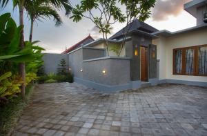 a house with a driveway in front of it at The Bagus in Kerobokan