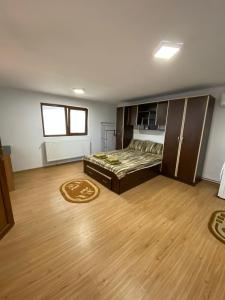 a bedroom with a bed and a wooden floor at Casa Rizea 