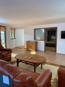 a living room with a couch and a table at Casa Rizea 