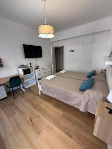 ローマにあるSemeria Suitesのベッドと机とテレビのある寝室