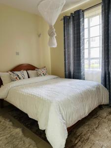 Ένα ή περισσότερα κρεβάτια σε δωμάτιο στο CJ Suites - Executive 2Br Near JKIA and SGR