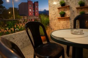 a table and chairs on a balcony with a table at Apto 201 Bed & Breakfast Sweet Home Medellín in Medellín
